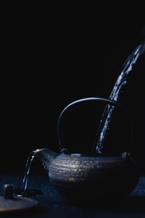 Free Water Overflowing from a Blue teapot Stock Photo