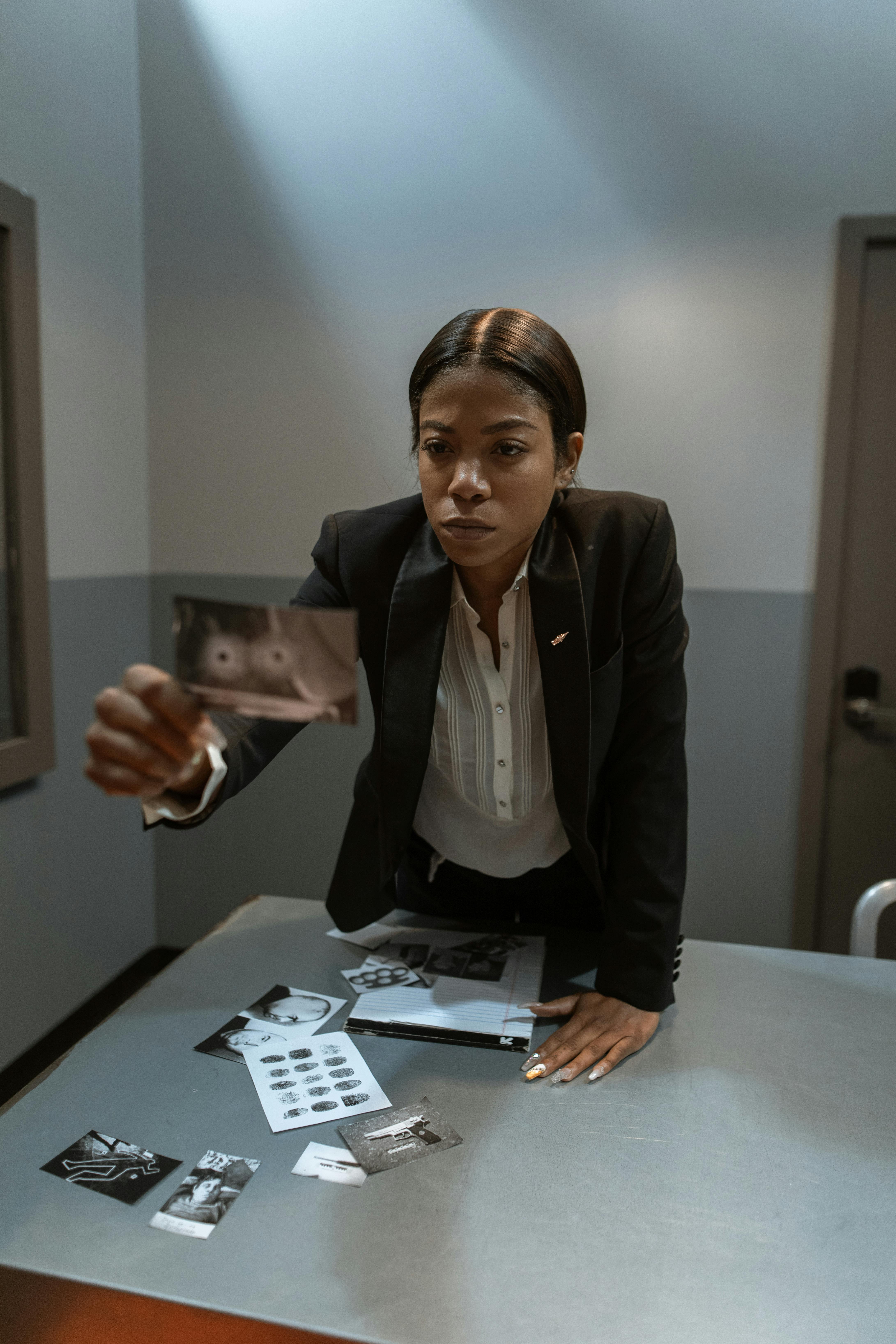 woman in black blazer sitting by the table