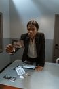 Woman in Black Blazer Sitting by the Table
