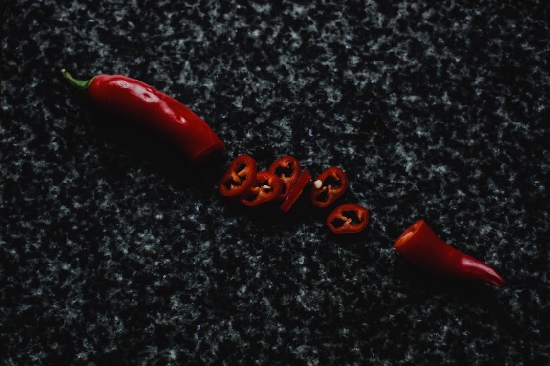 Sliced Red Chili on Black and Gray Marble · Free Stock Photo