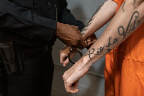 Free Handcuffing of a Tattooed Man Stock Photo