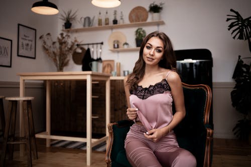 Stylish woman sitting on cozy armchair