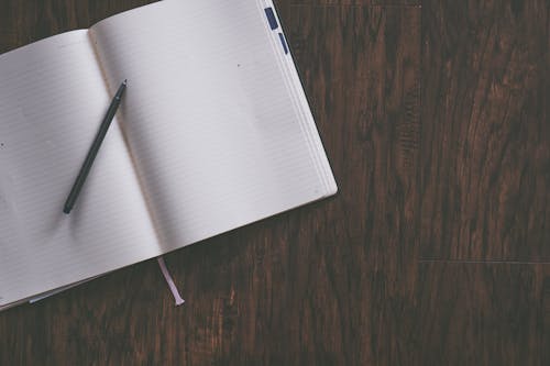 Free White Notebook and Pen Stock Photo