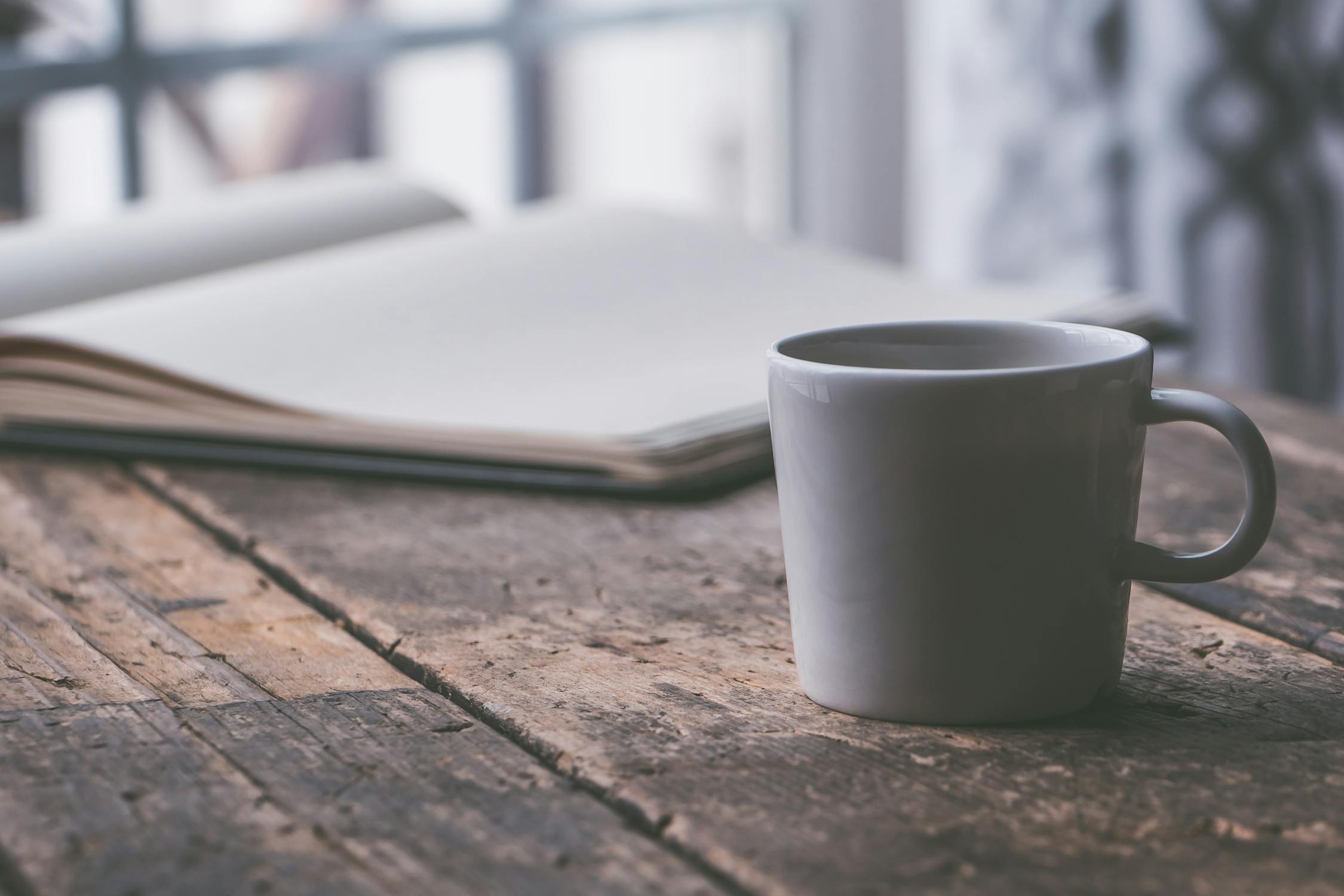 mug and notebook on desk