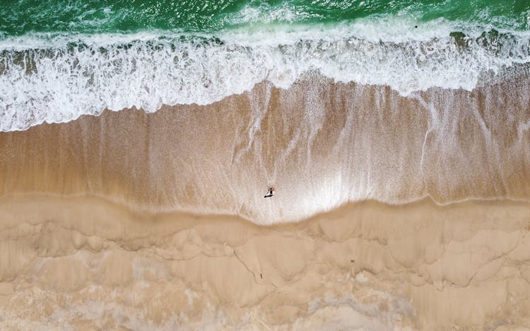 Aerial View Of Beach Waves On Shore