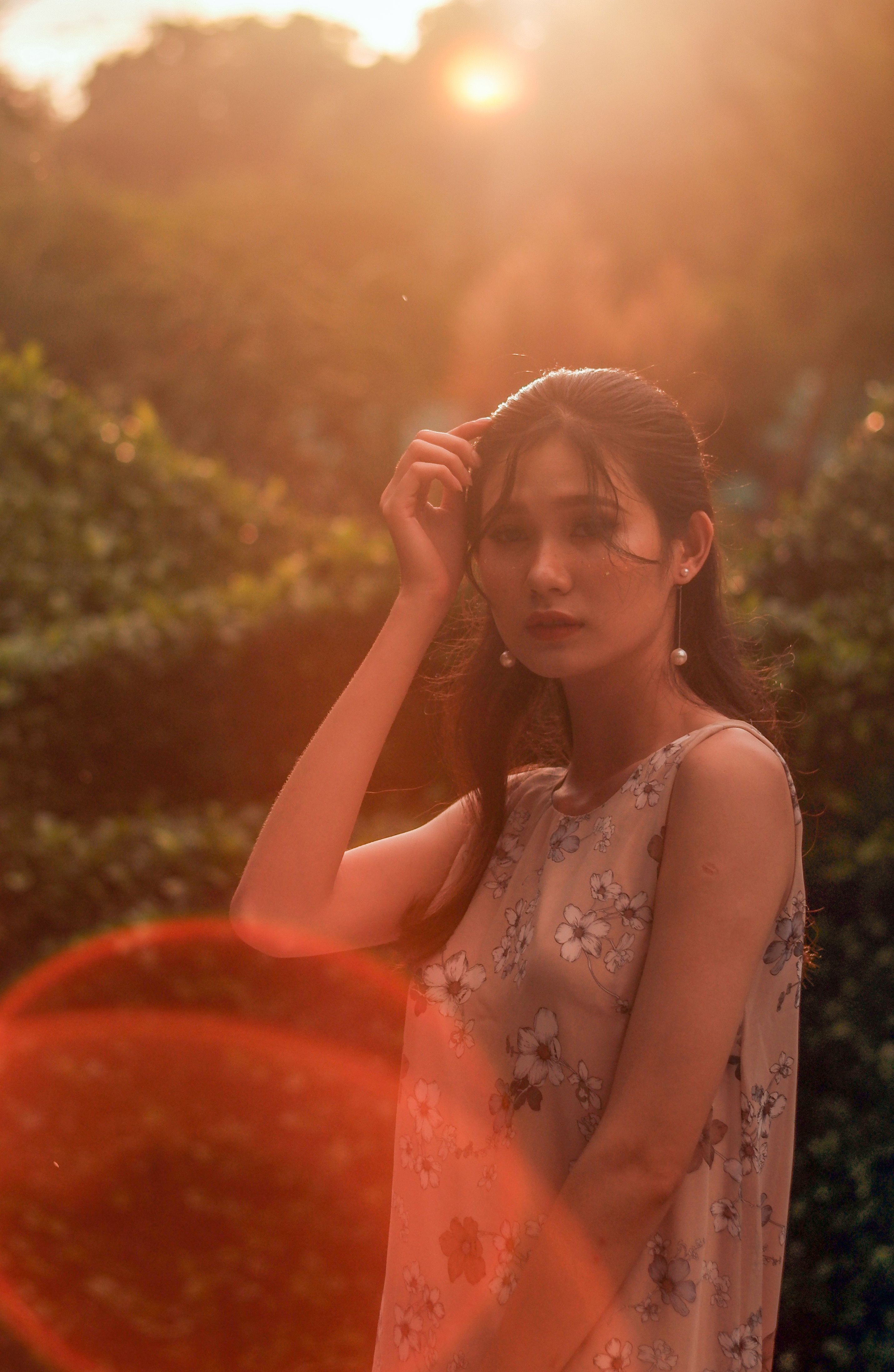 Woman in White Floral Tank Top Holding Her Hair · Free Stock Photo