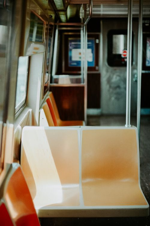 Free Vertical shot of empty seats inside a New York City subway train, capturing urban transport ambiance. Stock Photo