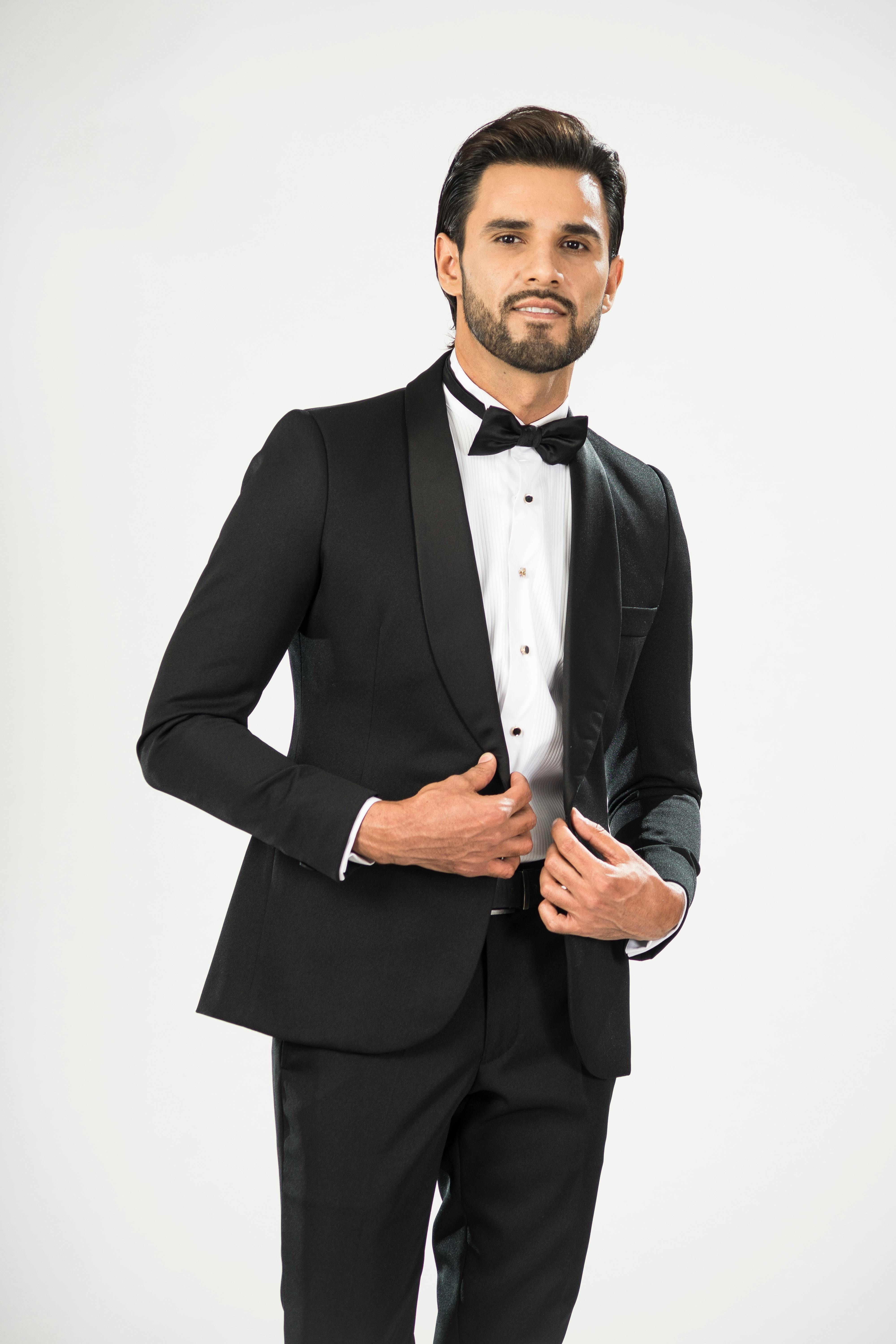 Man in Black Suit Jacket Standing and Smiling · Free Stock Photo