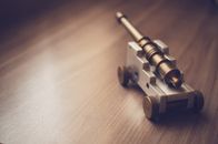 Grey Toy Cannon on a Beige Wooden Surface