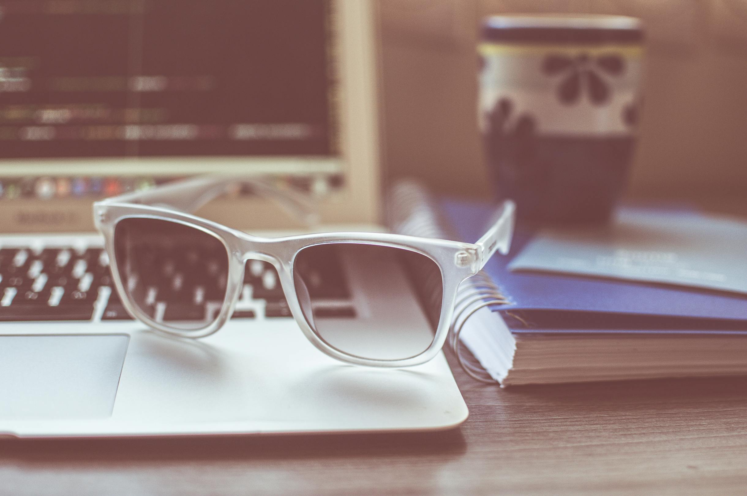 Businessman Holding Sunglasses And Looking At A Laptop High-Res Stock Photo  - Getty Images