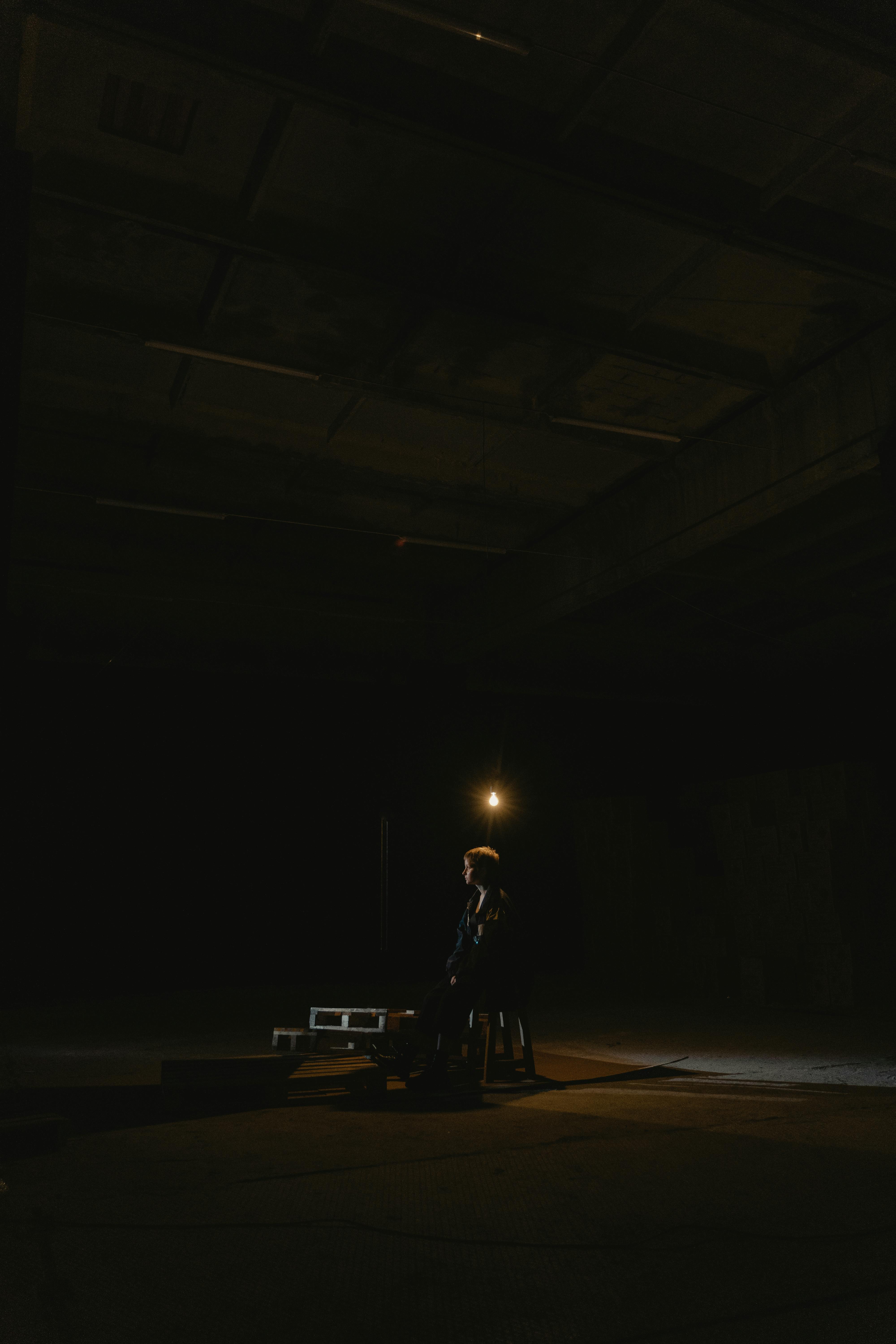 man sitting in the dark