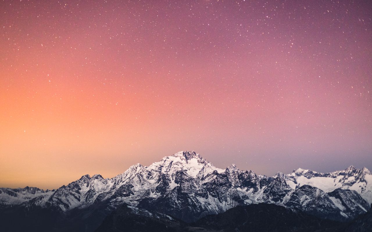 beautiful snow covered mountains under a starry sky at twilight in lan