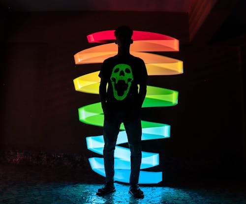Free Unrecognizable man near glowing neon lights Stock Photo