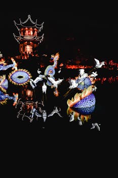 Beautiful dragon lanterns illuminating a tranquil lake at night in Montreal's vibrant festival.