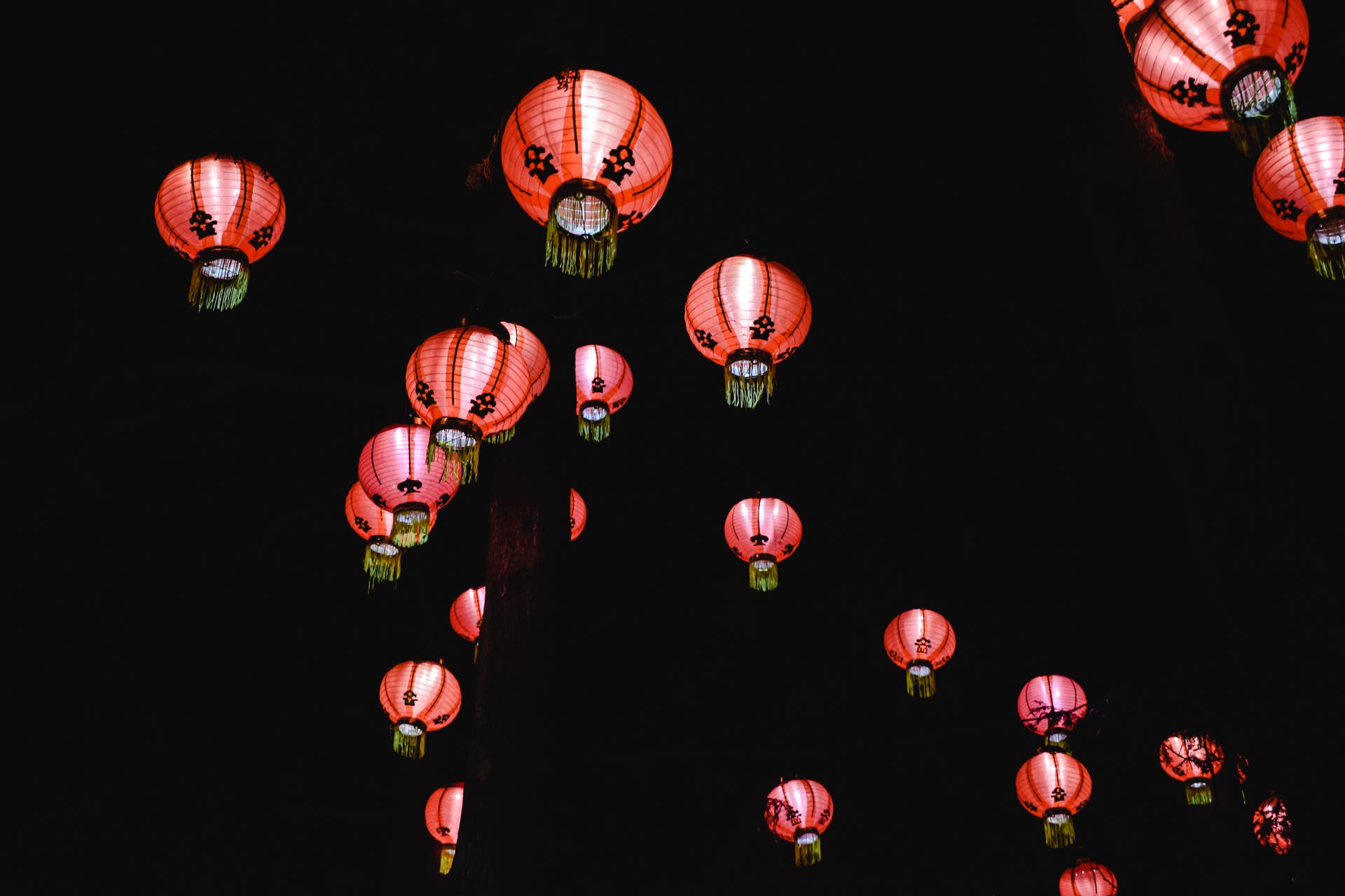 Red Chinese lanterns illuminating the night sky during a festival in Montreal.