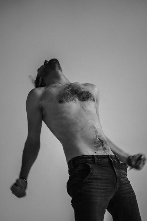 A Grayscale Photo of a Topless Man