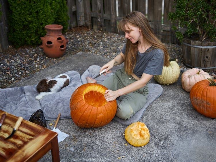 A Woman Carving A Pumpkin Decorations