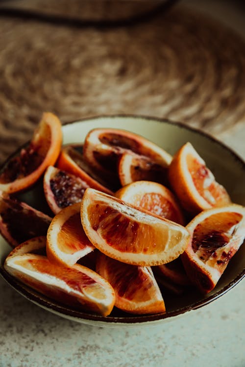 Close-Up Shot of Slices of Oranges on a Bowl