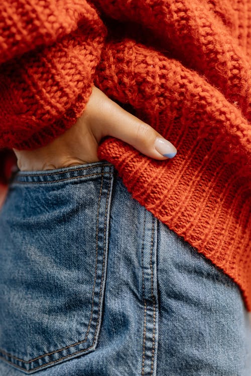 Free Person in Blue Denim Jeans and Red Knit Sweater Stock Photo