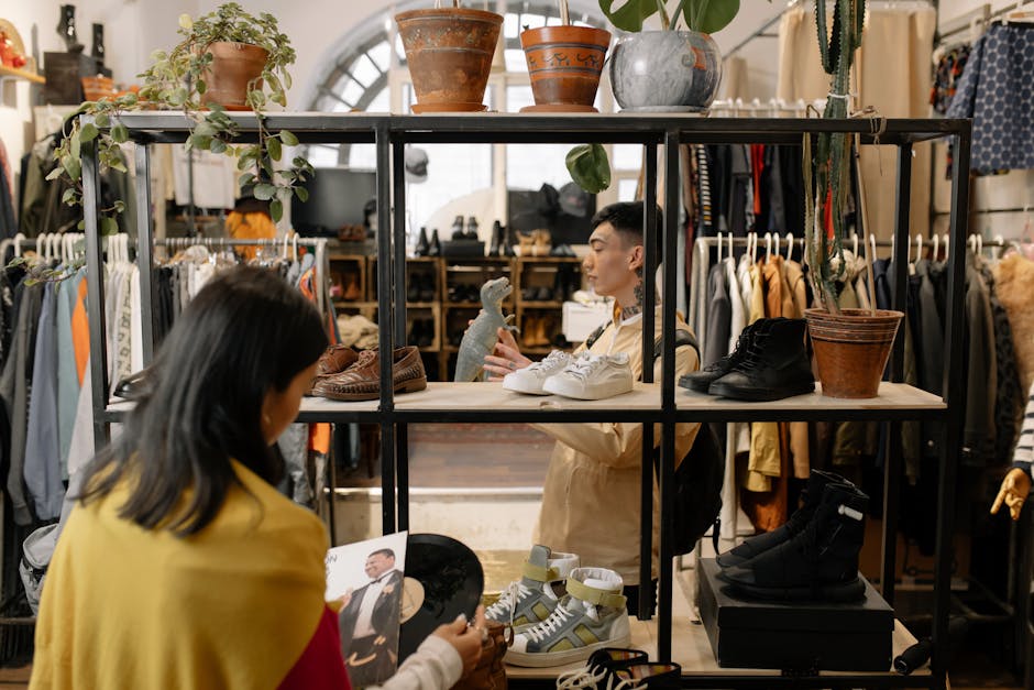 People browsing and selecting items in a stylish vintage clothing shop interior.