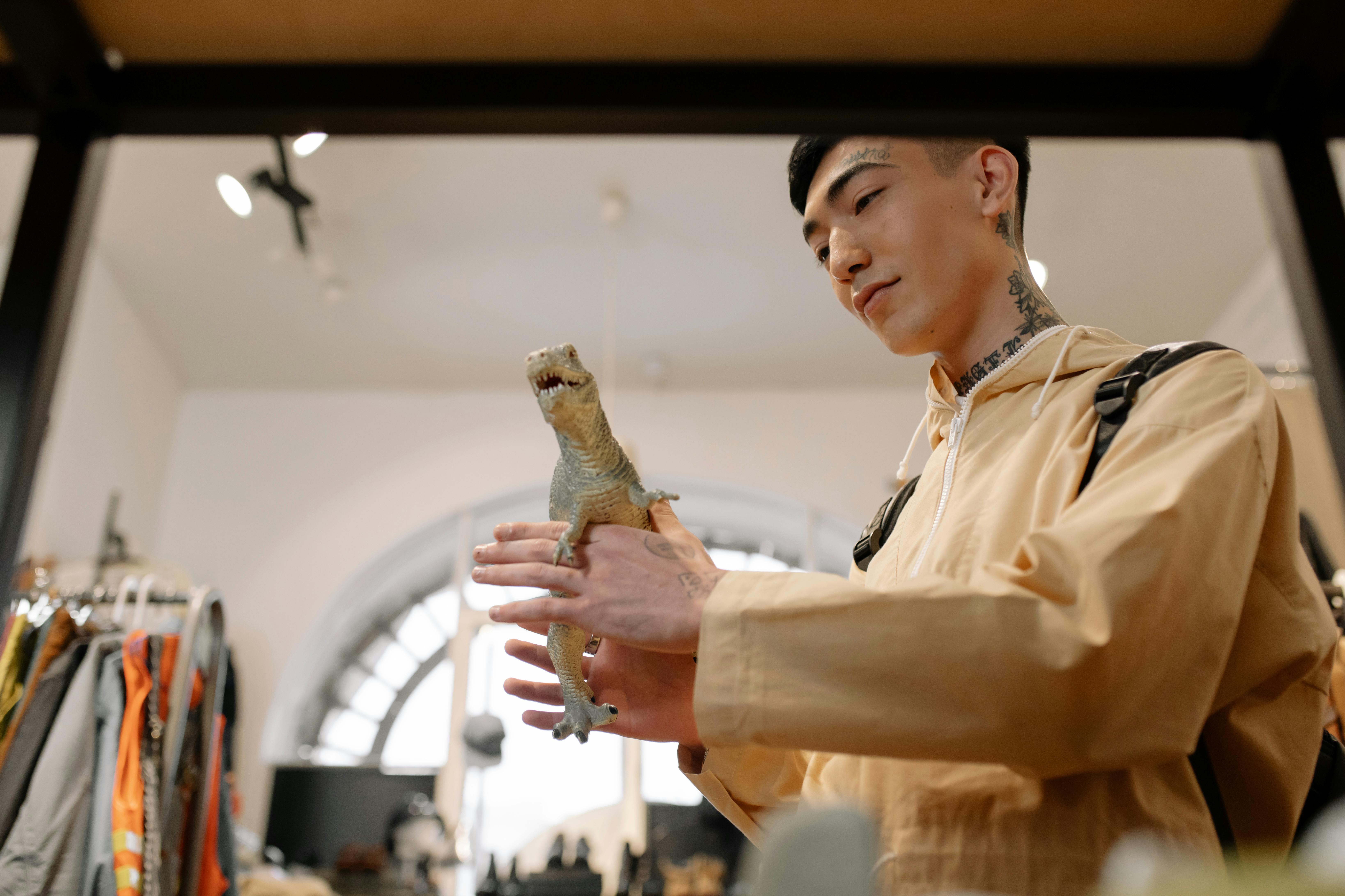 man in white button up shirt holding brown crocodile