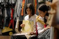 Woman in White Button Up Shirt Holding Yellow Paper