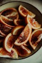 Sliced Orange Fruit on Black Plate