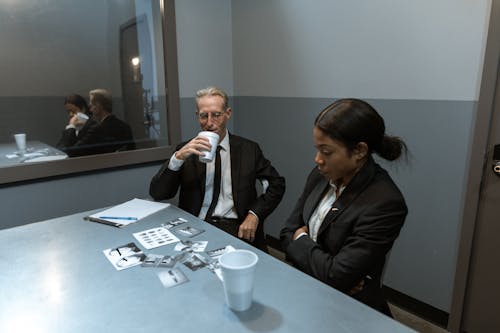 Free People in Black Suit Investigating a Case Stock Photo