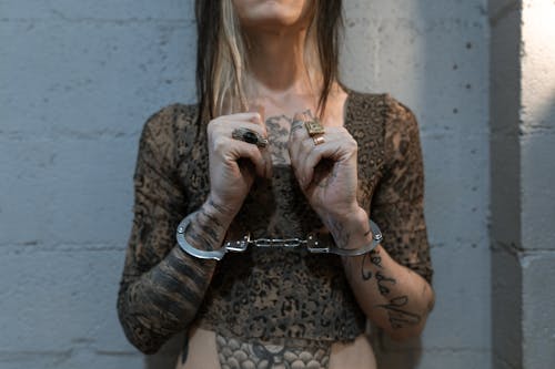 Free A Woman with Tattoo with Handcuffs Stock Photo