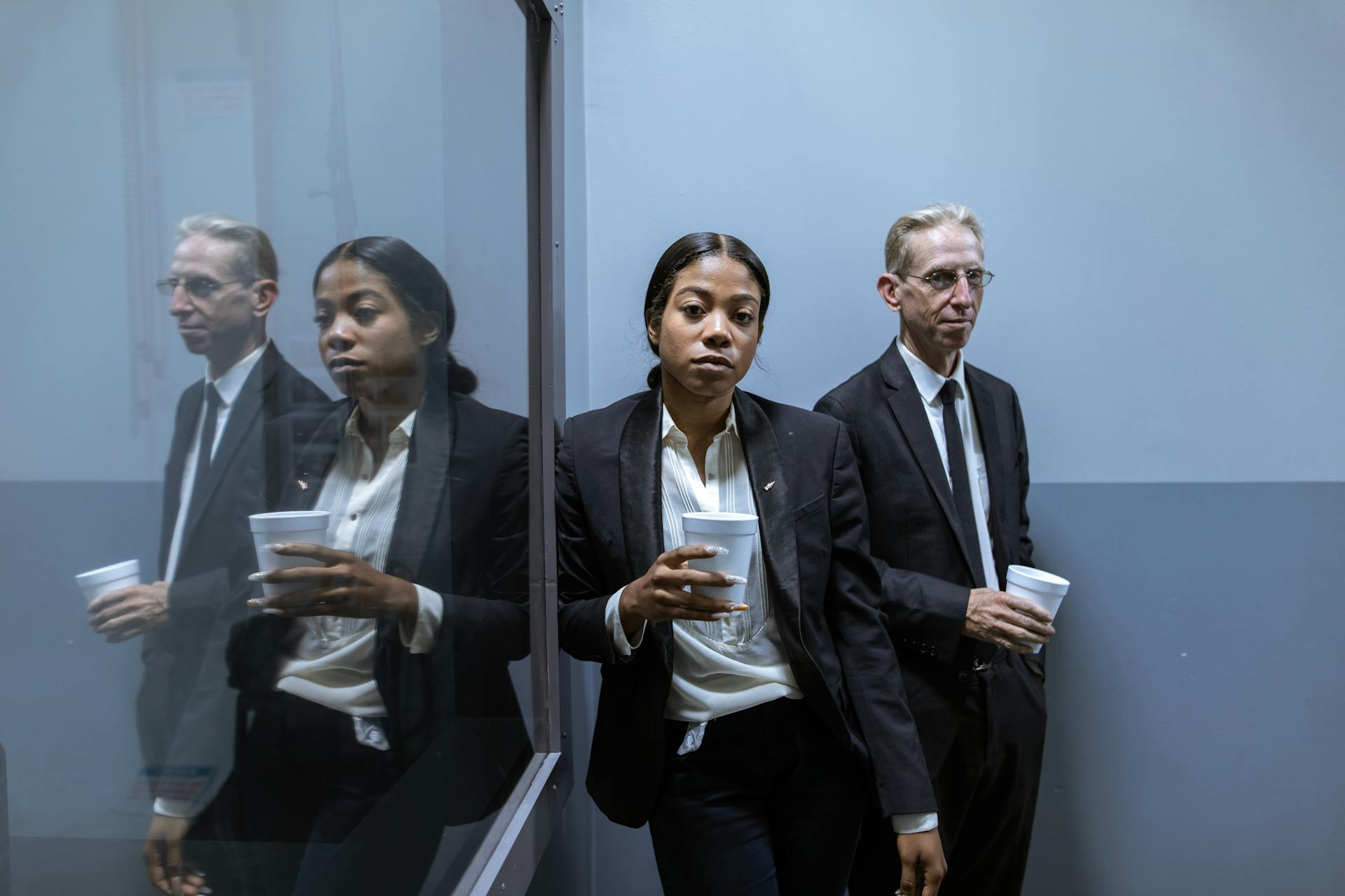 Man and Woman in Gray Suit Holding Coffee Cups