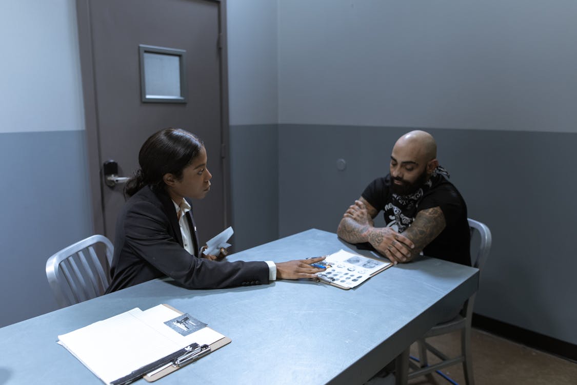 Free Man in Black Jacket Sitting Beside Man in Black Jacket Stock Photo
