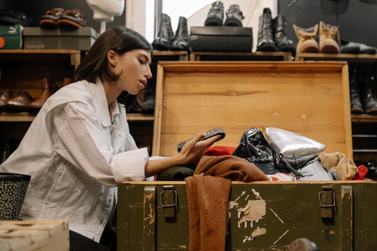 Woman Looking At The Coin Purse From The Wooden Box