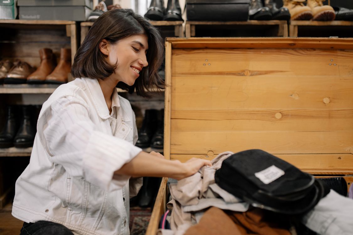 Free Woman in White Jacket Sitting beside Wooden Box Smiling Stock Photo
