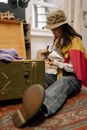 Woman in Yellow Shirt and Blue Denim Jeans Sitting on Floor