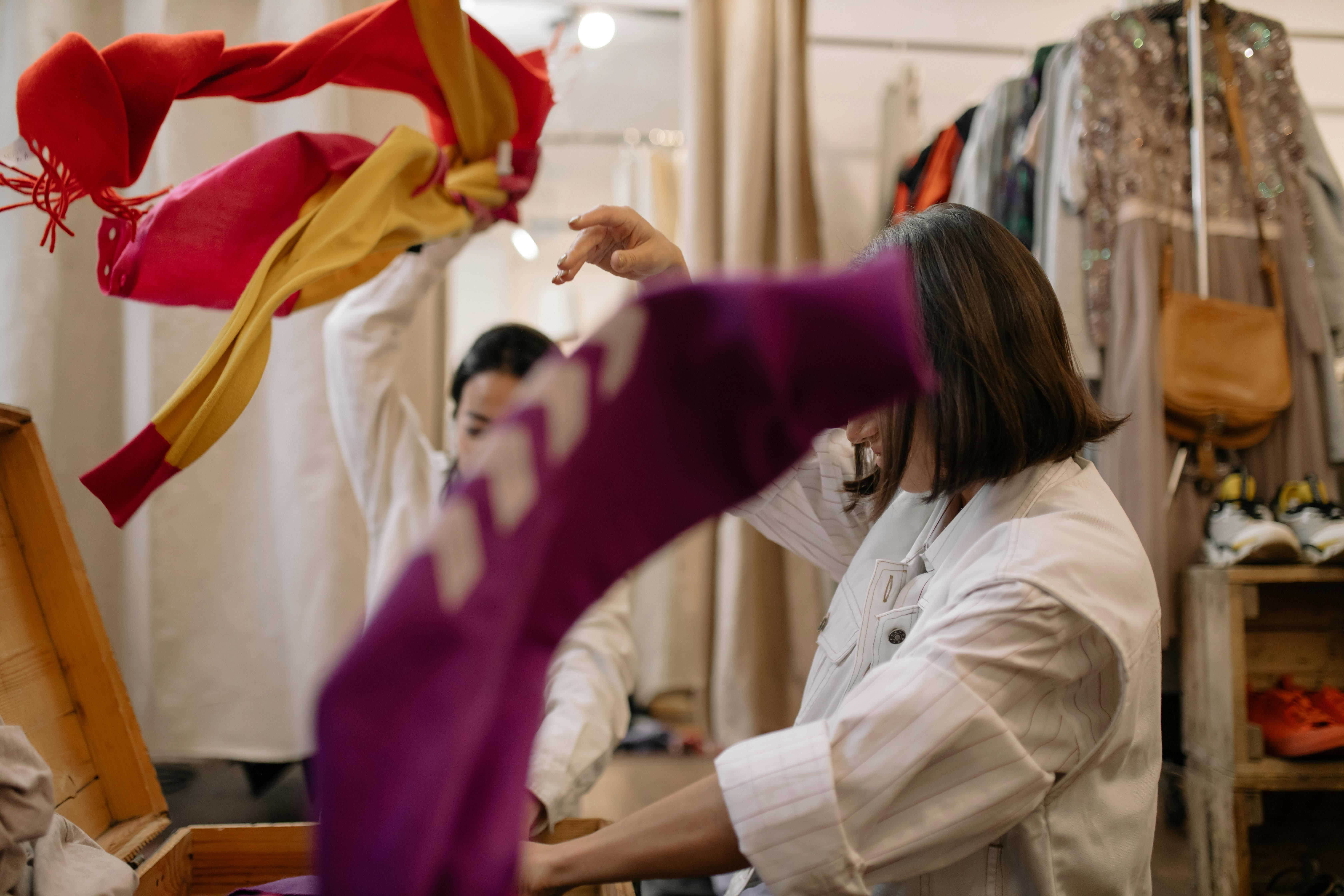 woman in white long sleeve shirt holding purple textile