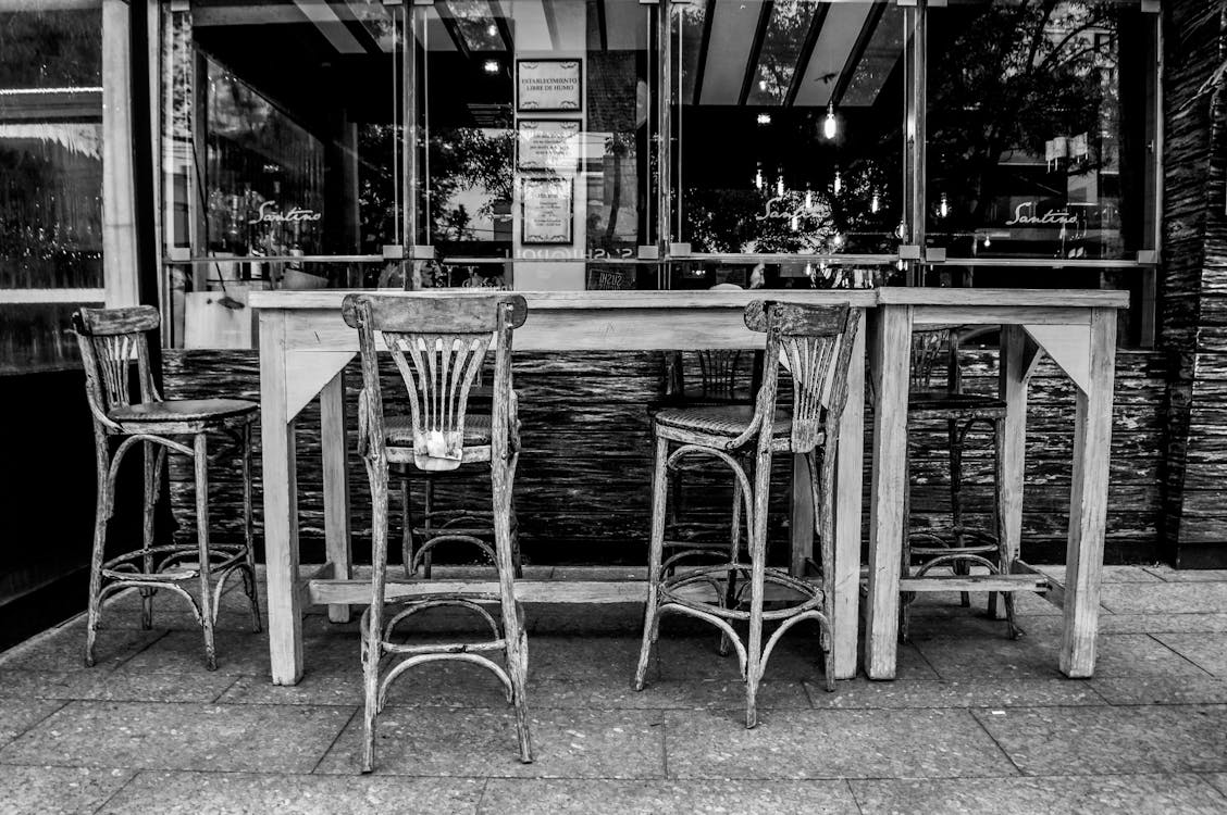 Grayscale Photo of Table and Chairs