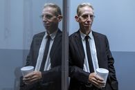 Man in Black Suit Holding White Disposable Cup