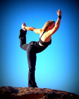 Woman in Black Sports Bra and Black Pants Exercise over the Brown Stone during Daytime
