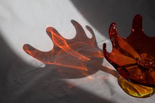 Shadow of unusual red transparent vase