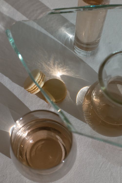 Macarons among glassware in sunlight