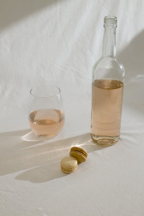Wine bottle with glass and macaroons