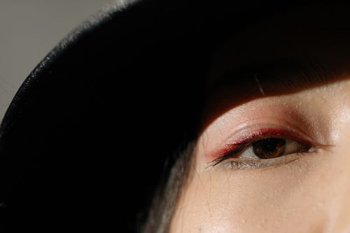 Free Artistic close-up of an eye with dramatic shadow and minimalistic lighting, creating an intense visual effect. Stock Photo