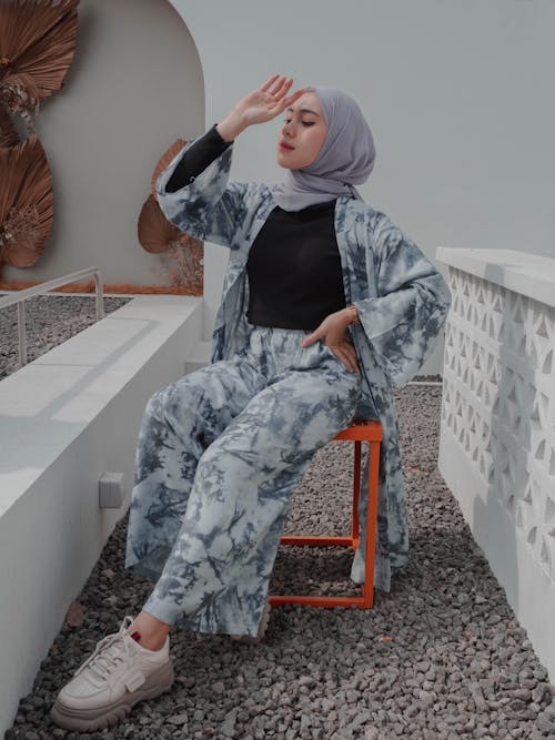 Fashionable Muslim woman sitting gracefully on chair