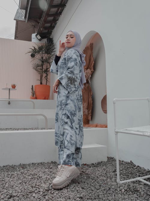 Stylish Muslim woman standing graciously on backyard
