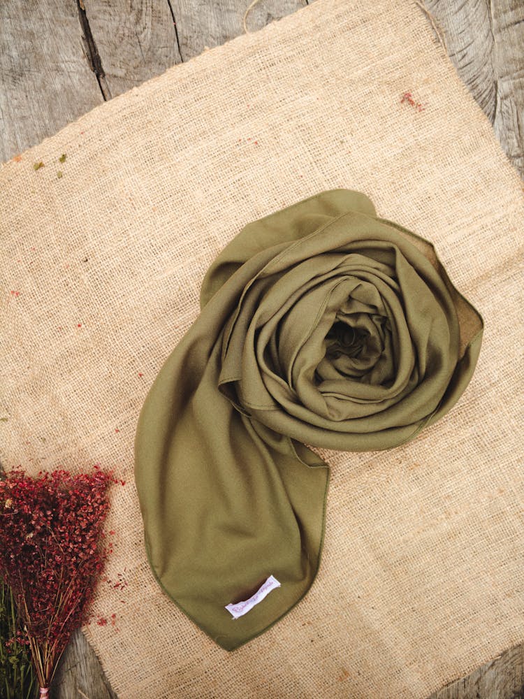 Trendy Silk Scarf Placed Near Flowers On Table