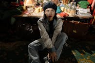 A Woman Sitting Wearing White Long Sleeve Shirt