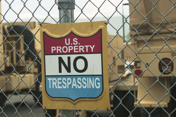 A Signage On Metal Chain Link Fence Gate