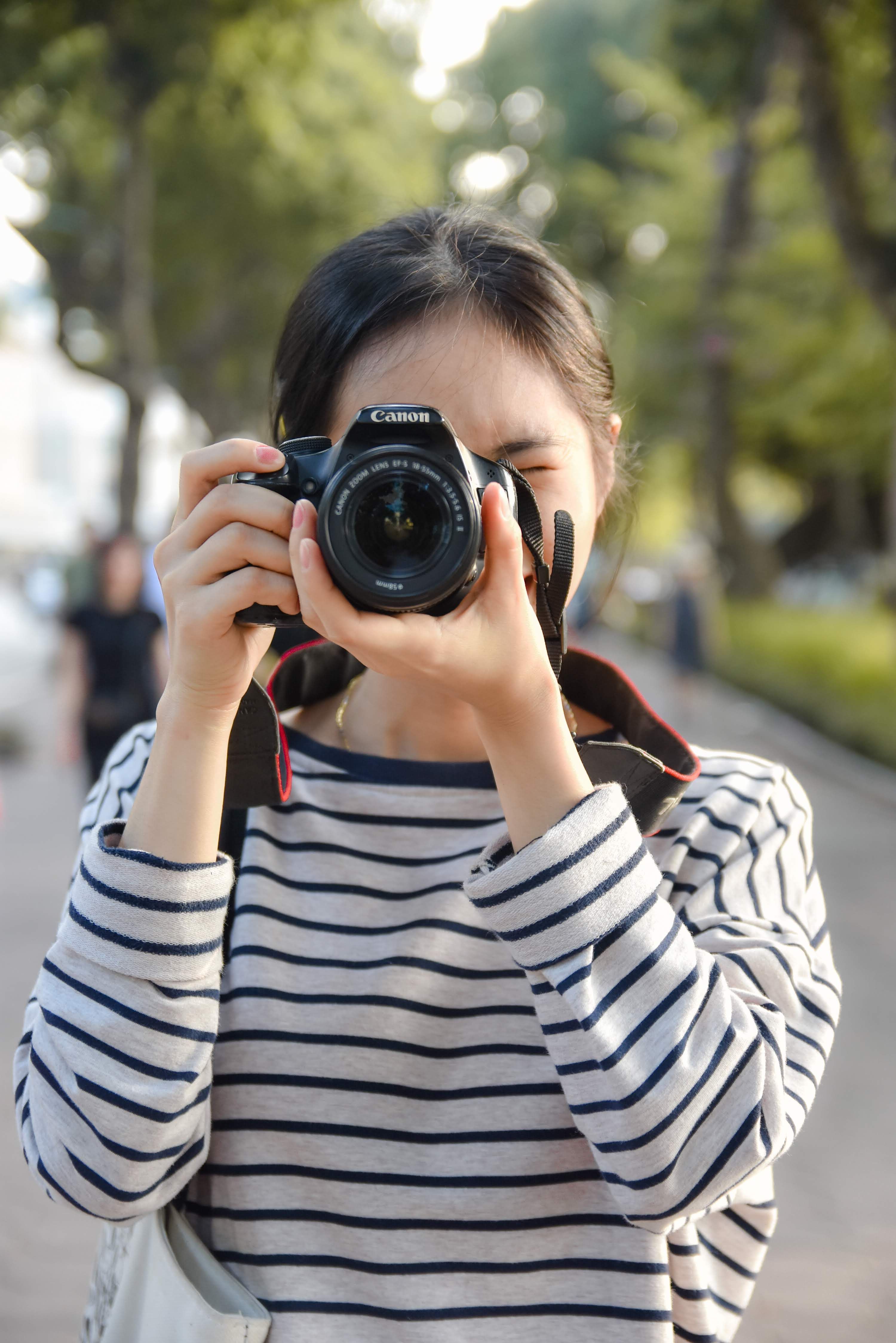 Portrait of Woman Taking a Picture with a Camera · Free Stock Photo