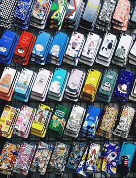A colorful collection of various cartoon-themed phone cases arranged in rows, perfect for mobile accessory enthusiasts.