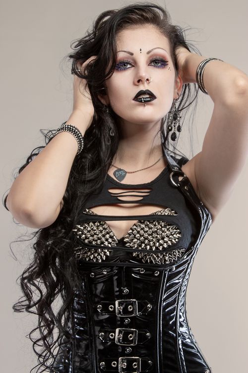 Free Model posing in gothic fashion with black lipstick and striking accessories. Stock Photo